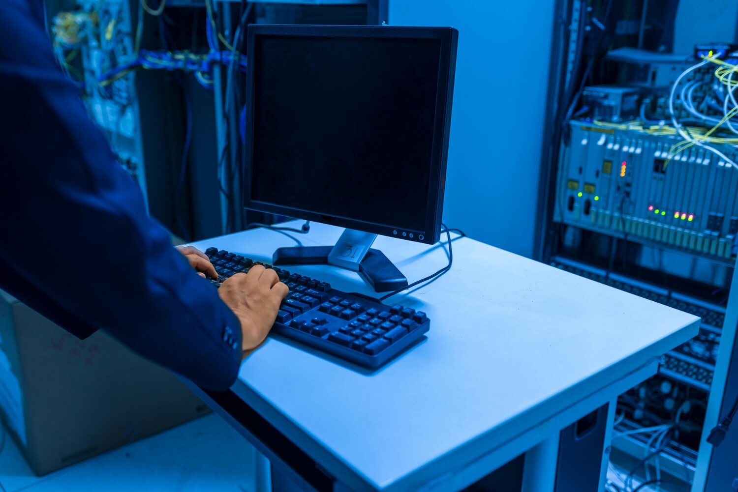 Technician workstation beside server and network equipment